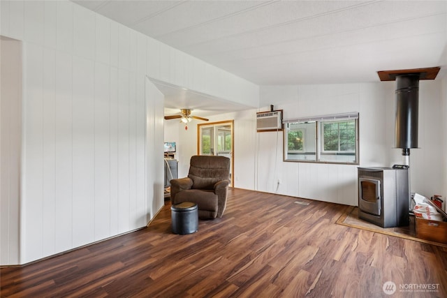 35605 158th St SE, Sultan, WA 98294 - living area featuring wood finished floors, a wood stove, and a wall mounted air conditioner