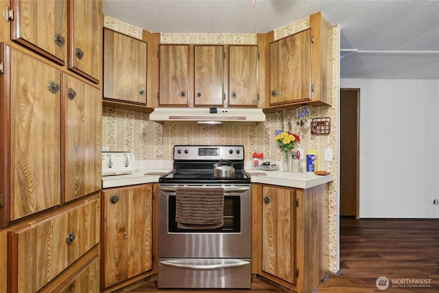 35605 158th St SE, Sultan, WA 98294 - kitchen with electric stove, under cabinet range hood, light countertops, brown cabinets, and dark wood finished floors