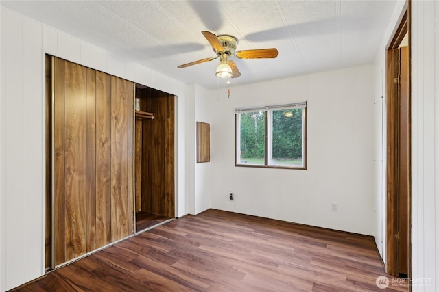 35605 158th St SE, Sultan, WA 98294 - unfurnished bedroom with wood finished floors, a closet, and a ceiling fan