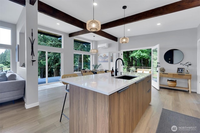 4902 Weber Rd, Snohomish, WA 98290 - kitchen with modern cabinets, a sink, beam ceiling, open floor plan, and light wood-style floors
