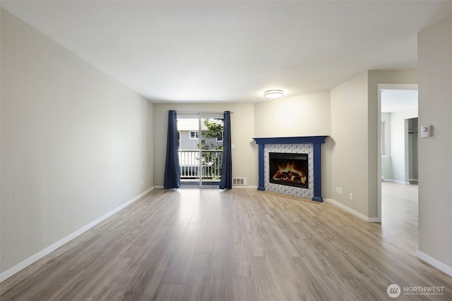 1132 N 198th St Unit C204, Shoreline, WA 98133 - unfurnished living room featuring wood finished floors and a fireplace