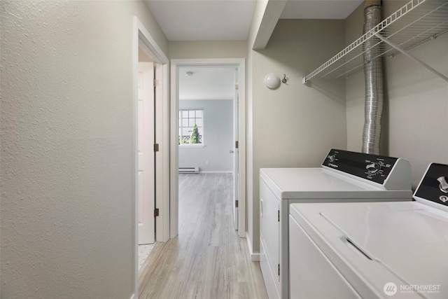 1132 N 198th St Unit C204, Shoreline, WA 98133 - laundry area with washer and dryer, light wood-style floors, and a baseboard heating unit