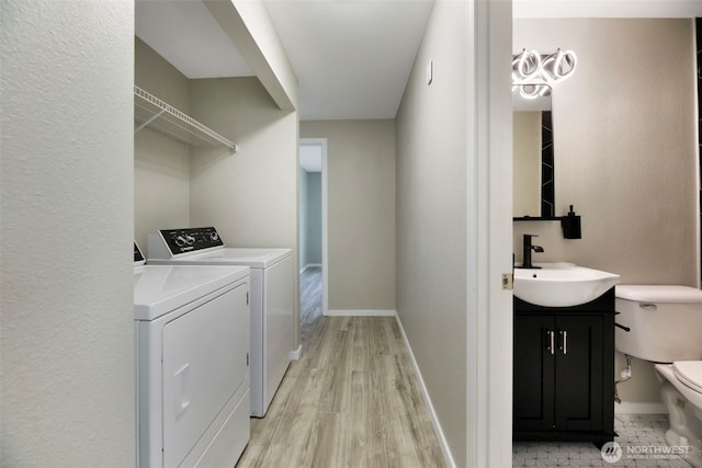1132 N 198th St Unit C204, Shoreline, WA 98133 - washroom featuring independent washer and dryer and light wood finished floors