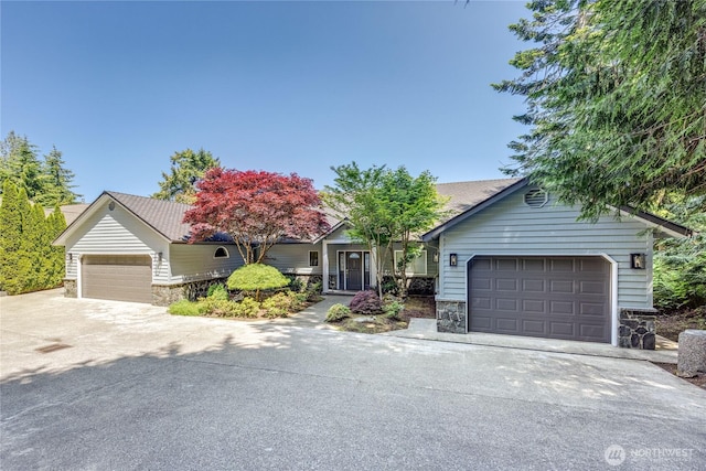 873 Olele Point Rd, Port Ludlow, WA 98365 - view of front facade with stone siding and concrete driveway