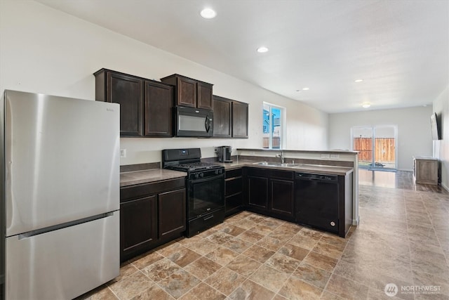 19218 18th Avenue Ct E, Spanaway, WA 98387 - kitchen featuring black appliances, a peninsula, dark brown cabinetry, recessed lighting, and light stone finish floors