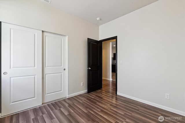 19218 18th Avenue Ct E, Spanaway, WA 98387 - unfurnished bedroom with dark wood-style flooring and a closet