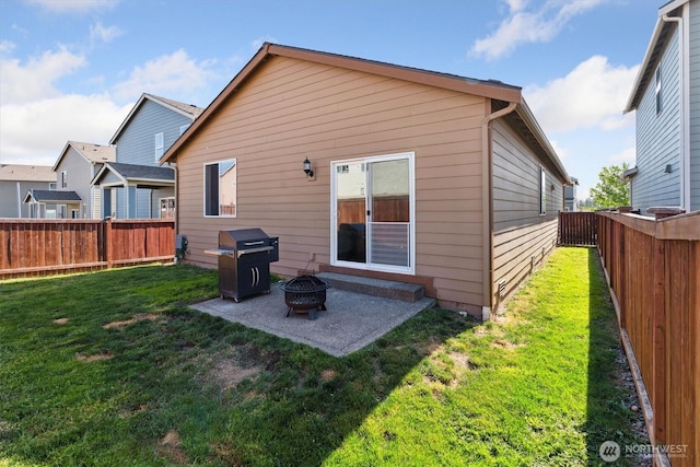 19218 18th Avenue Ct E, Spanaway, WA 98387 - rear view of property with a fire pit, a patio, and a fenced backyard