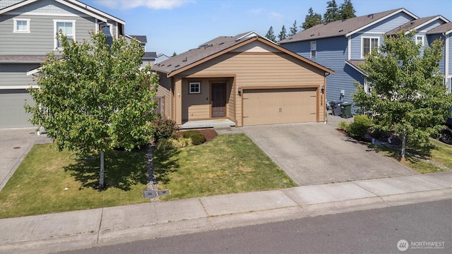 19218 18th Avenue Ct E, Spanaway, WA 98387 - view of front of house with driveway, an attached garage, and a front yard