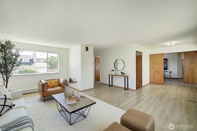 6424 32nd Ave S, Seattle, WA 98118 - living room featuring a baseboard heating unit, a textured ceiling, and light wood-style floors