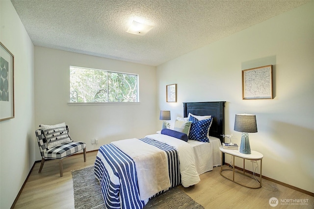 6424 32nd Ave S, Seattle, WA 98118 - bedroom with wood finished floors, a textured ceiling, and baseboards