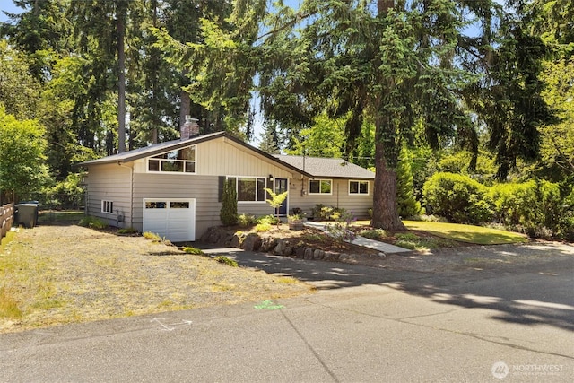 10502 240th Pl SW, Edmonds, WA 98020 - view of front of house featuring a chimney, an attached garage, and driveway
