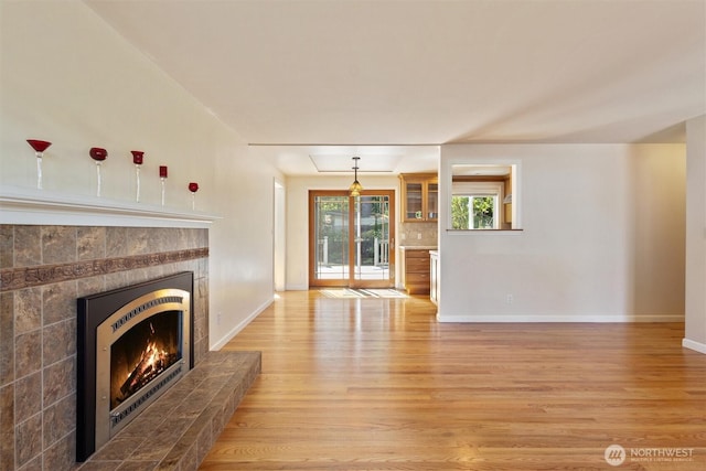 10502 240th Pl SW, Edmonds, WA 98020 - unfurnished living room featuring light wood-style floors, a fireplace, and baseboards