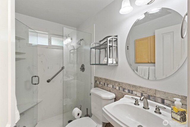10502 240th Pl SW, Edmonds, WA 98020 - full bathroom featuring a sink, a shower stall, toilet, tile walls, and a wainscoted wall
