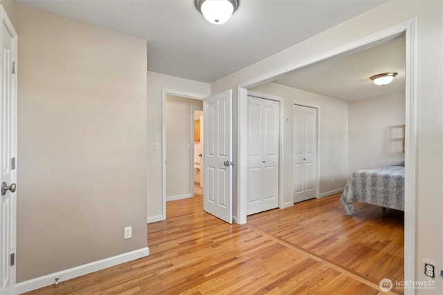 10502 240th Pl SW, Edmonds, WA 98020 - bedroom with two closets, light wood-style flooring, and baseboards