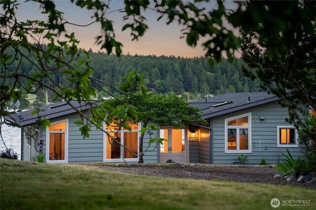 1794 Bayshore Rd, Lopez Island, WA 98261 - view of front of property featuring a forest view and a yard