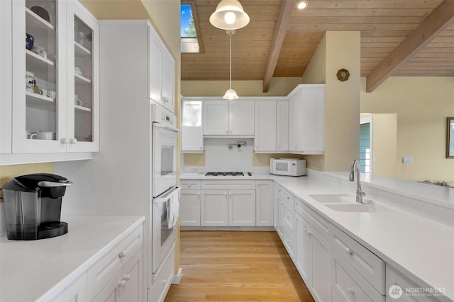 1794 Bayshore Rd, Lopez Island, WA 98261 - kitchen with a sink, wood ceiling, white cabinets, white appliances, and glass insert cabinets