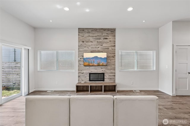 7724 16th Ave SW, Seattle, WA 98106 - unfurnished living room with wood finished floors, recessed lighting, baseboards, and a fireplace