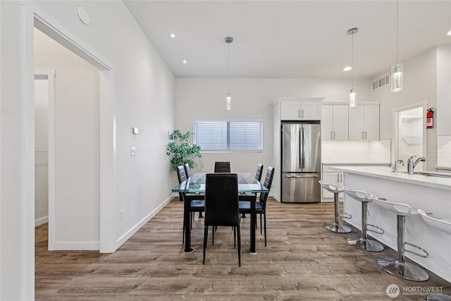 7724 16th Ave SW, Seattle, WA 98106 - dining space with wood finished floors, recessed lighting, and baseboards