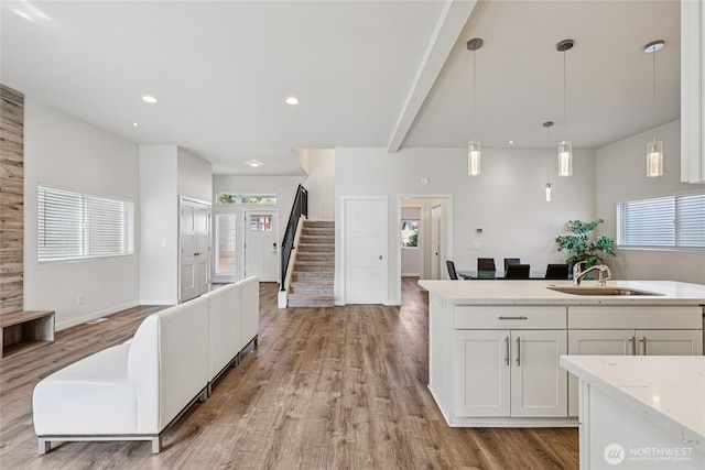 7724 16th Ave SW, Seattle, WA 98106 - kitchen featuring a sink, open floor plan, light wood-style flooring, white cabinetry, and recessed lighting