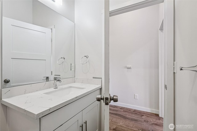 7724 16th Ave SW, Seattle, WA 98106 - bathroom featuring wood finished floors, vanity, and baseboards