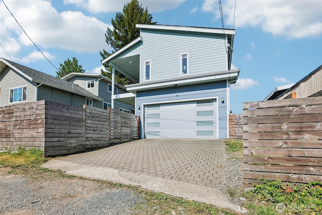 7724 16th Ave SW, Seattle, WA 98106 - view of front facade with an attached garage and driveway