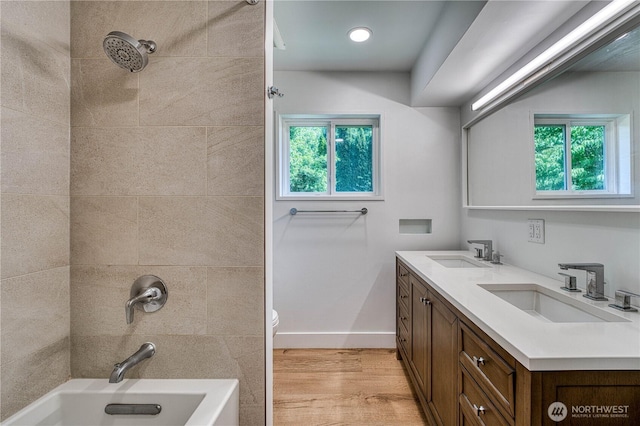 925 Front St S, Issaquah, WA 98027 - bathroom featuring double vanity, healthy amount of natural light, wood finished floors, and shower / tub combination