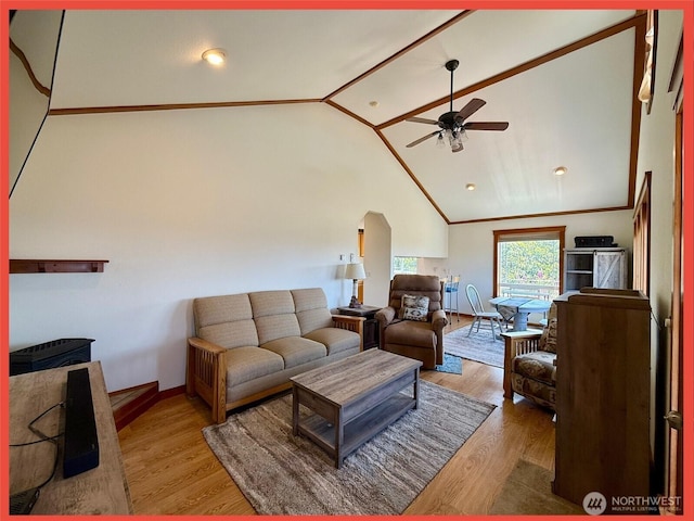486 Winlock St, Ocean Shores, WA 98569 - living area featuring ceiling fan, lofted ceiling, wood finished floors, and arched walkways