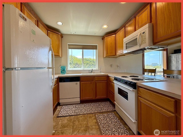 486 Winlock St, Ocean Shores, WA 98569 - kitchen with white appliances, recessed lighting, light countertops, and brown cabinets