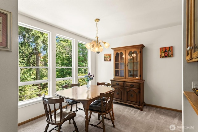 625 N Jackson Ave Unit A9, Tacoma, WA 98406 - dining area featuring a chandelier, baseboards, and light colored carpet