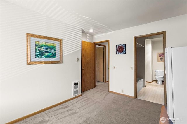 625 N Jackson Ave Unit A9, Tacoma, WA 98406 - unfurnished bedroom featuring freestanding refrigerator, heating unit, carpet, baseboards, and ensuite bath