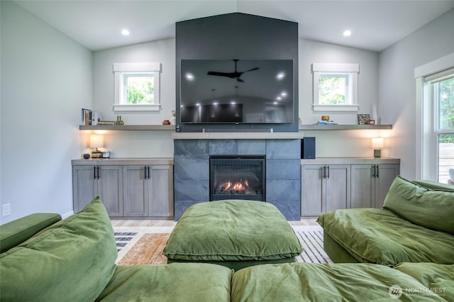 366 Lake View Loop NE, Ocean Shores, WA 98569 - living area featuring vaulted ceiling, light wood-type flooring, a tiled fireplace, and recessed lighting