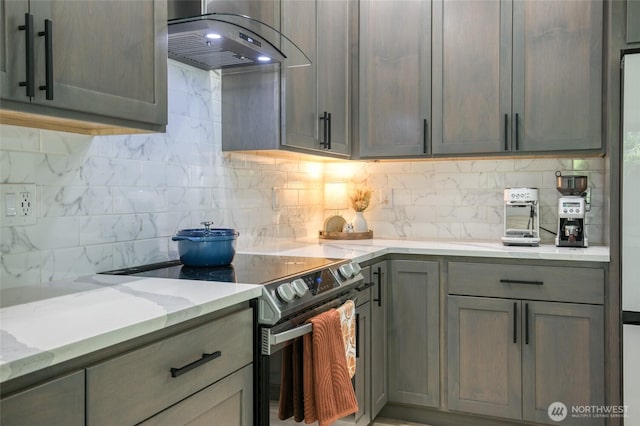 366 Lake View Loop NE, Ocean Shores, WA 98569 - kitchen featuring stainless steel electric stove, range hood, decorative backsplash, light stone counters, and gray cabinetry