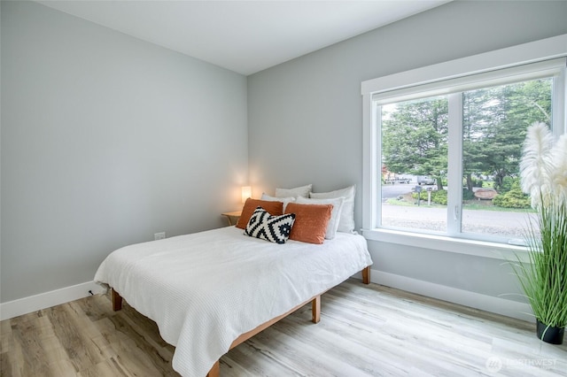 366 Lake View Loop NE, Ocean Shores, WA 98569 - bedroom with multiple windows, baseboards, and wood finished floors