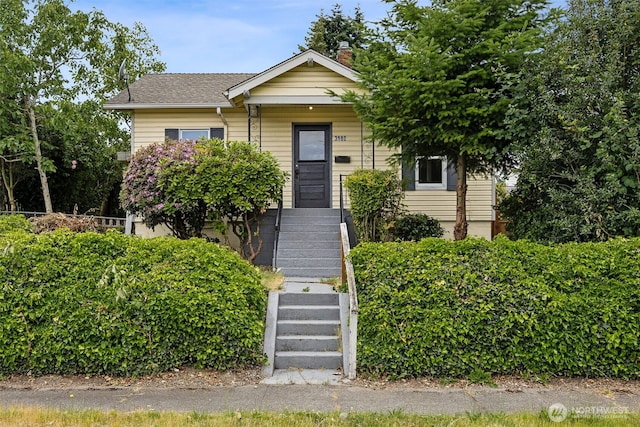 3586 E L St, Tacoma, WA 98404 - view of front facade with stairway, a shingled roof, and a chimney