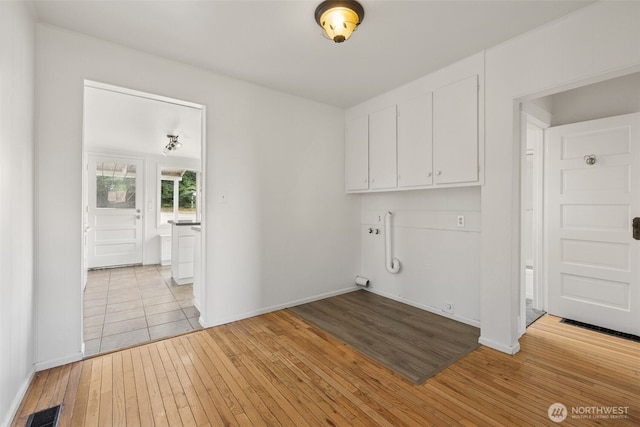 3586 E L St, Tacoma, WA 98404 - washroom featuring cabinet space, light wood-type flooring, and baseboards