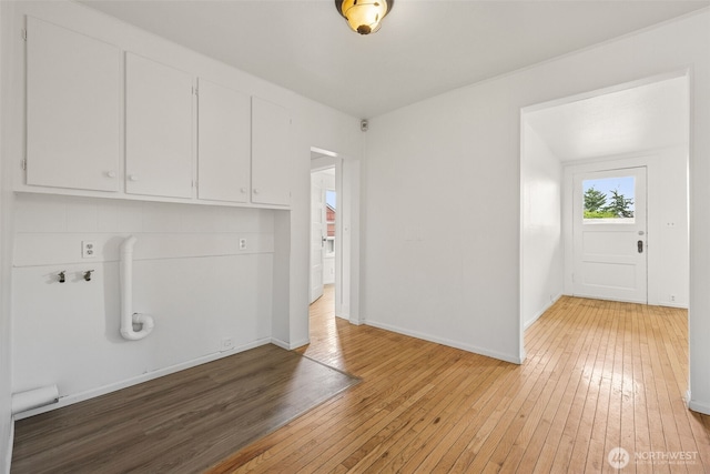 3586 E L St, Tacoma, WA 98404 - laundry area with cabinet space, light wood-style floors, and baseboards