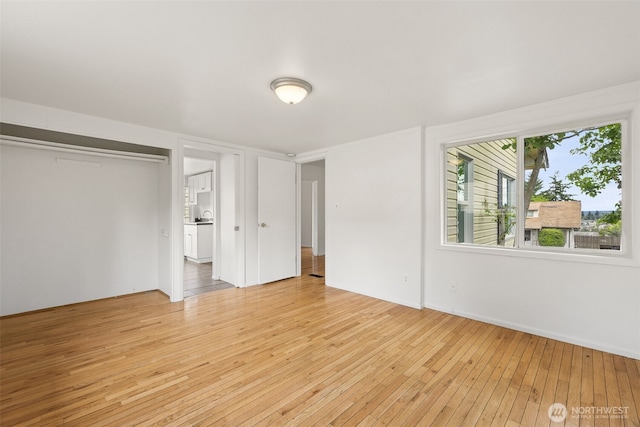 3586 E L St, Tacoma, WA 98404 - unfurnished bedroom with light wood-type flooring, baseboards, and a closet
