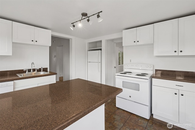 3586 E L St, Tacoma, WA 98404 - kitchen with white appliances, a sink, dark countertops, and white cabinetry