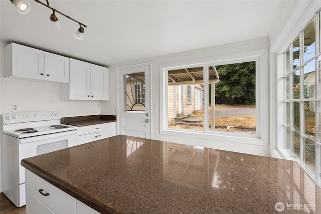 3586 E L St, Tacoma, WA 98404 - kitchen with white range with electric stovetop, white cabinets, and dark stone countertops