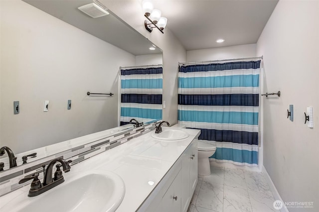 107 Lone Ram Ln, Wenatchee, WA 98801 - bathroom featuring marble finish flooring, toilet, double vanity, baseboards, and recessed lighting