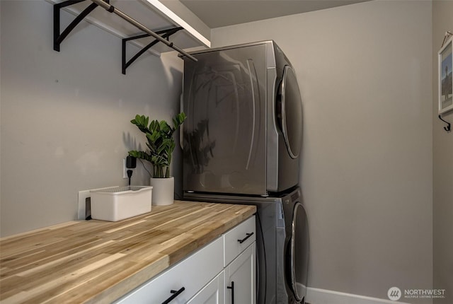 107 Lone Ram Ln, Wenatchee, WA 98801 - washroom featuring estacked washer and dryer and cabinet space
