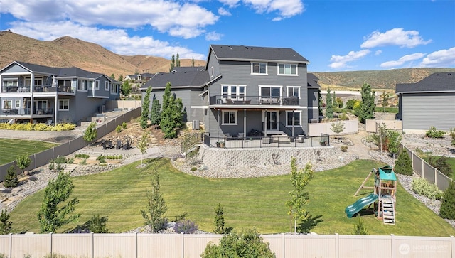 107 Lone Ram Ln, Wenatchee, WA 98801 - back of house featuring a playground, a deck with mountain view, and a patio area