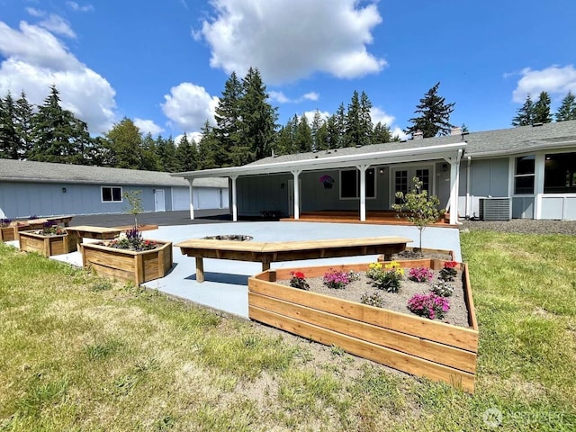 4012 267th St E, Spanaway, WA 98387 - back of property featuring a vegetable garden, central AC, and a lawn
