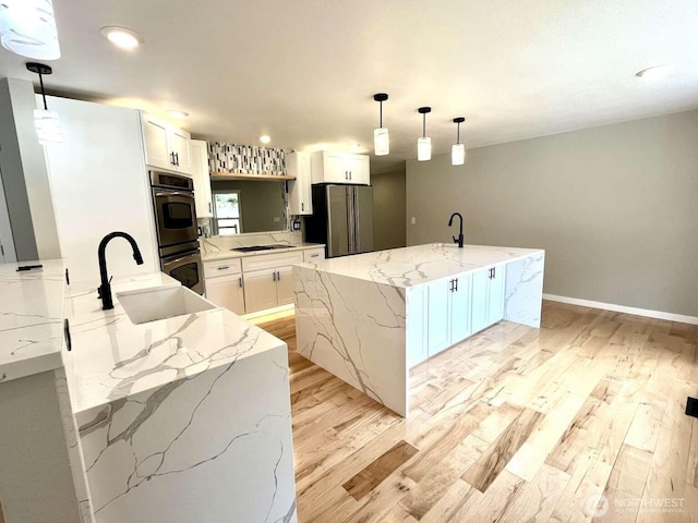 4012 267th St E, Spanaway, WA 98387 - kitchen with appliances with stainless steel finishes, light wood-style flooring, a sink, white cabinets, and recessed lighting