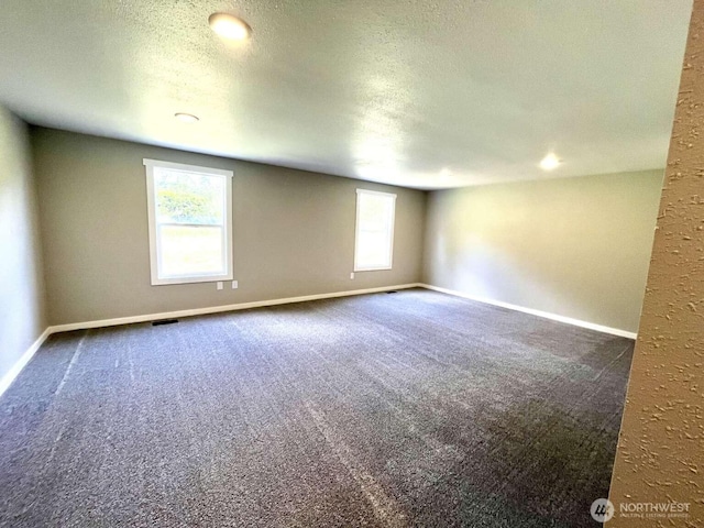 4012 267th St E, Spanaway, WA 98387 - unfurnished room featuring dark carpet, a textured ceiling, and baseboards