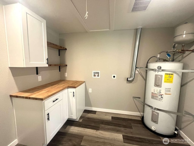 4012 267th St E, Spanaway, WA 98387 - laundry room with water heater, hookup for an electric dryer, hookup for a washing machine, dark wood finished floors, and baseboards