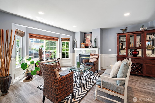 1314 N 182nd Pl, Shoreline, WA 98133 - living area with wood finished floors, wainscoting, a glass covered fireplace, recessed lighting, and a decorative wall