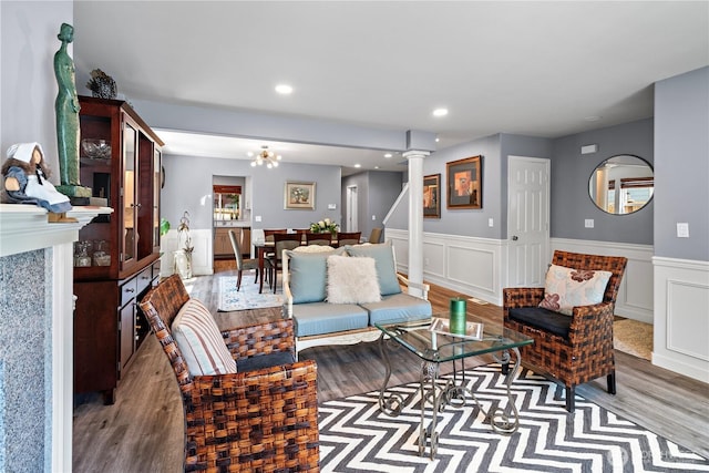 1314 N 182nd Pl, Shoreline, WA 98133 - living room with wood finished floors, a wainscoted wall, ornate columns, recessed lighting, and a decorative wall