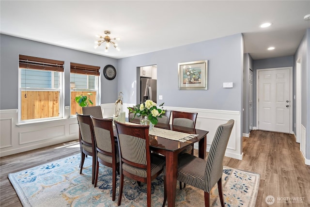 1314 N 182nd Pl, Shoreline, WA 98133 - dining space with light wood-type flooring, a wainscoted wall, a chandelier, and recessed lighting