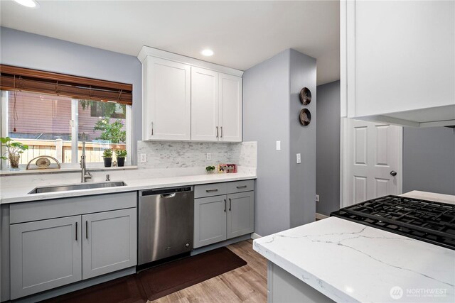 1314 N 182nd Pl, Shoreline, WA 98133 - kitchen featuring dishwasher, a sink, gray cabinetry, light wood-style flooring, and decorative backsplash